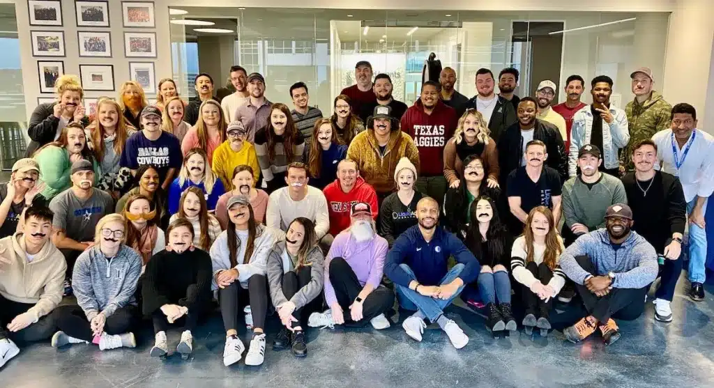 Group Photo of employees wearing fake mustaches