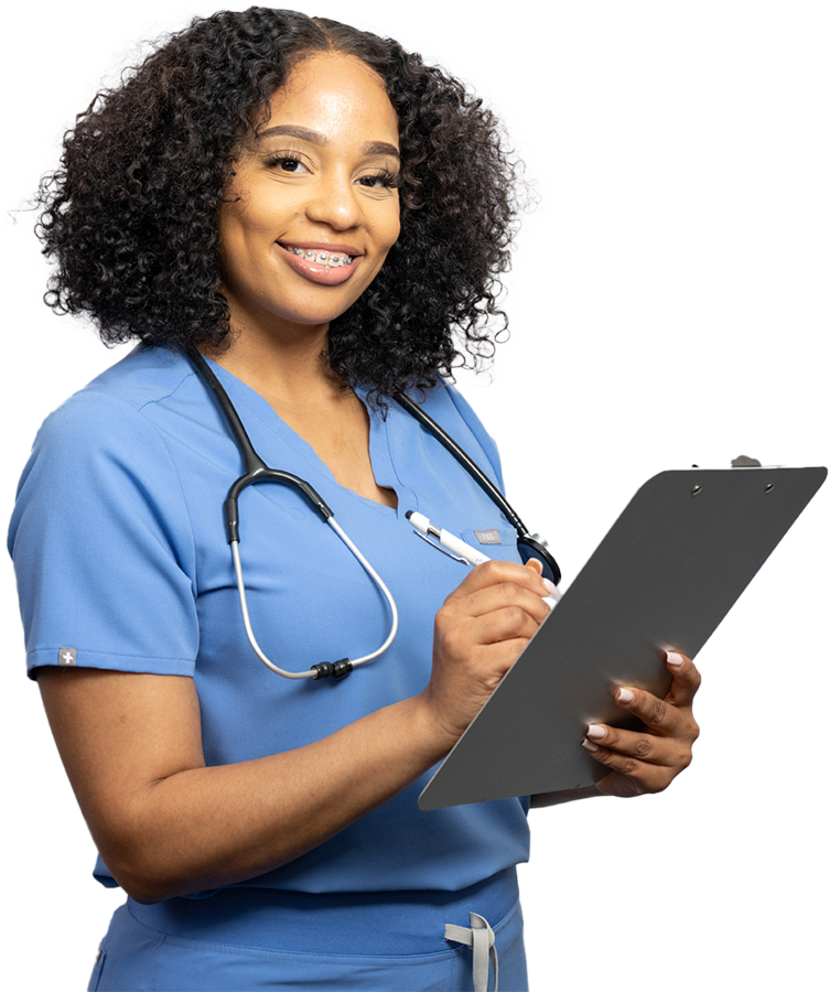 Female healthcare worker in scrubs smiling holding a clipboard and pen